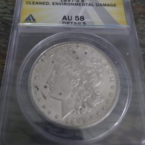 1897-S MORGAN SILVER DOLLAR GRADED AU58 CLEANED, DAMAGE BY ANACS
